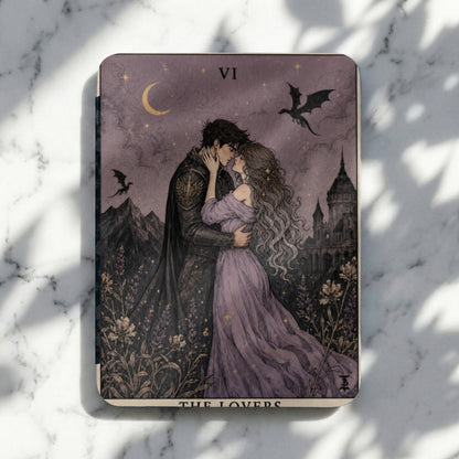 Tarot card VI The Lovers depicts a couple embracing under a crescent moon with dragons and a castle.