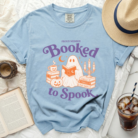 Light blue t-shirt with ghost reading books, "Proud Member Booked to Spook" graphic.