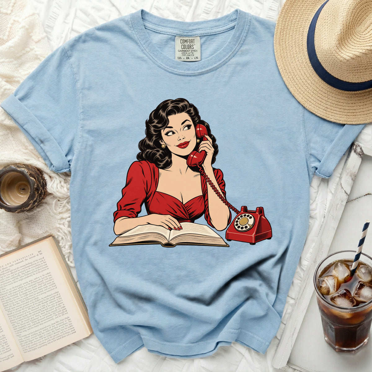Light blue t-shirt with a retro illustration of a woman on the phone.