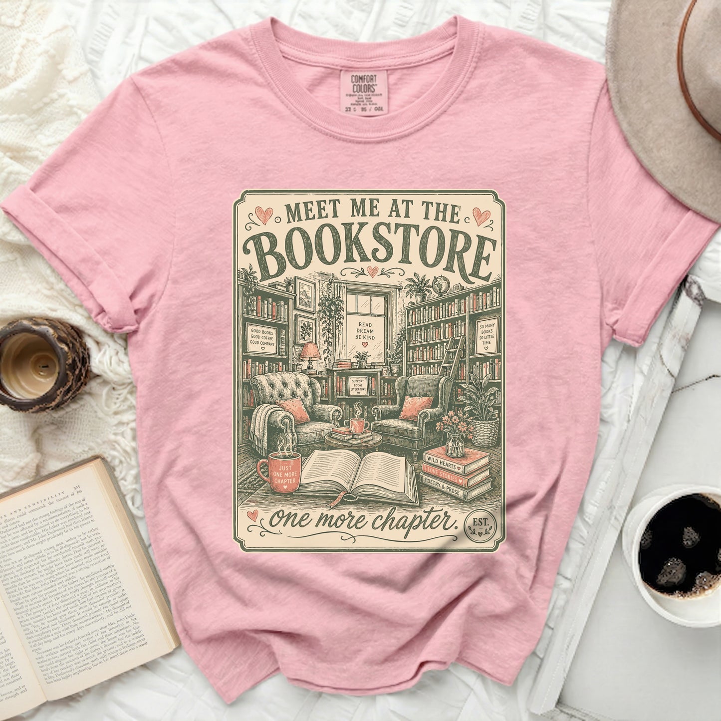 Pink t-shirt with a "Meet me at the bookstore" graphic.