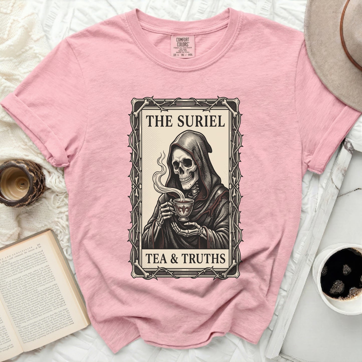 Pink t-shirt with grim reaper holding tea, text "THE SURIEL TEA & TRUTHS".