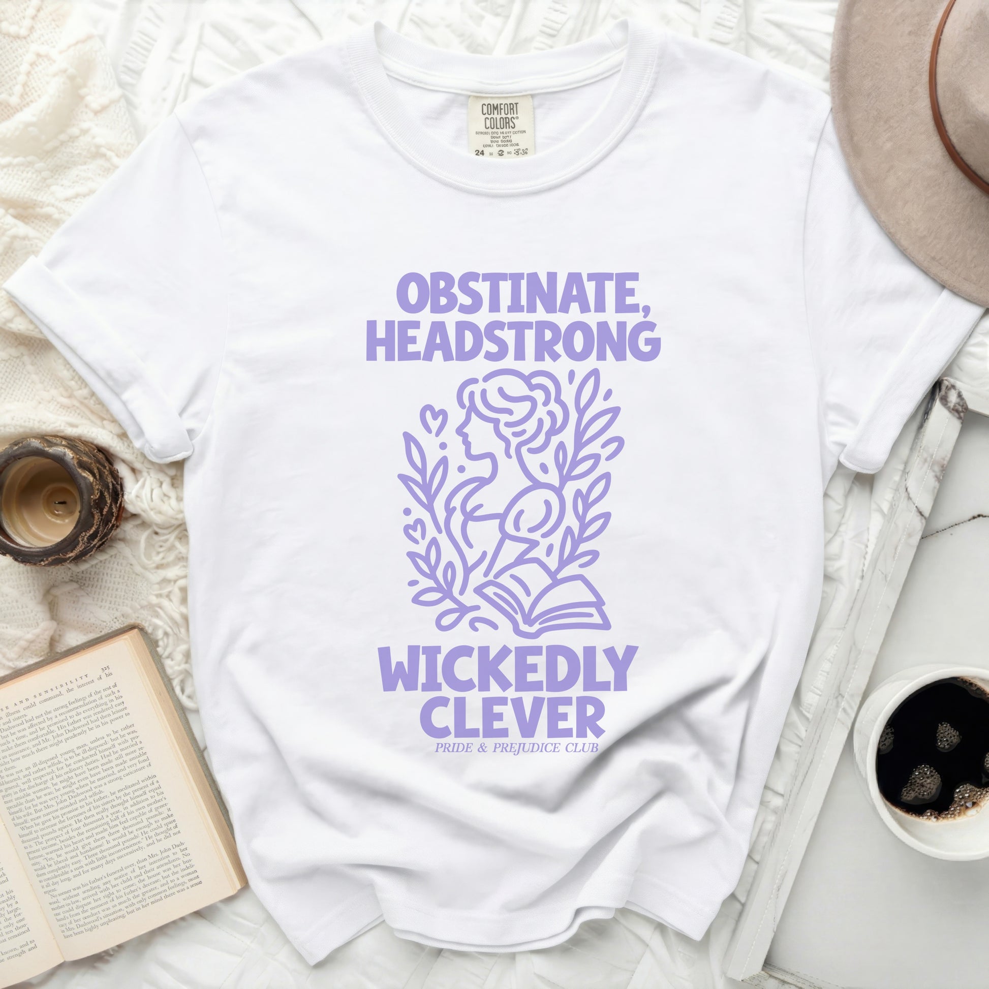 White t-shirt with lilac text "Obstinate, Headstrong, Wickedly Clever".