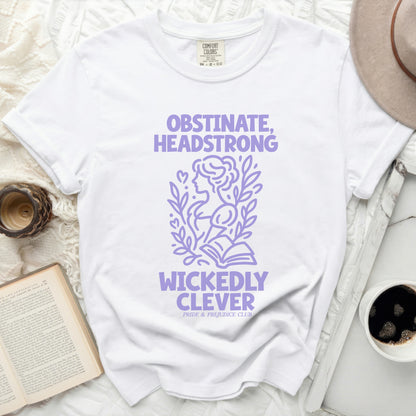 White t-shirt with lilac text "Obstinate, Headstrong, Wickedly Clever".