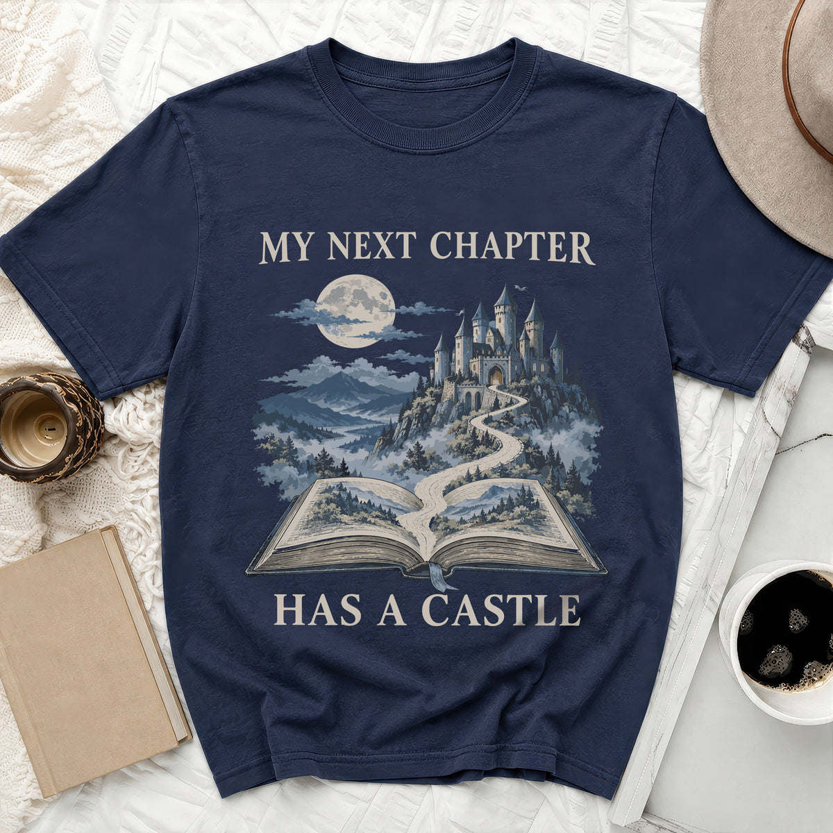 Dark blue t-shirt with "MY NEXT CHAPTER HAS A CASTLE" and a castle on an open book.