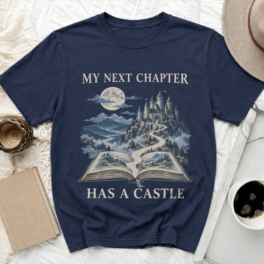 Dark blue t-shirt with "MY NEXT CHAPTER HAS A CASTLE" and a castle on an open book.