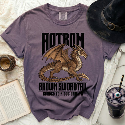 Purple t-shirt with dragon graphic and text "AOTROM BROWN SWORDTAU BONDED TO RIDOC GAMLYN".