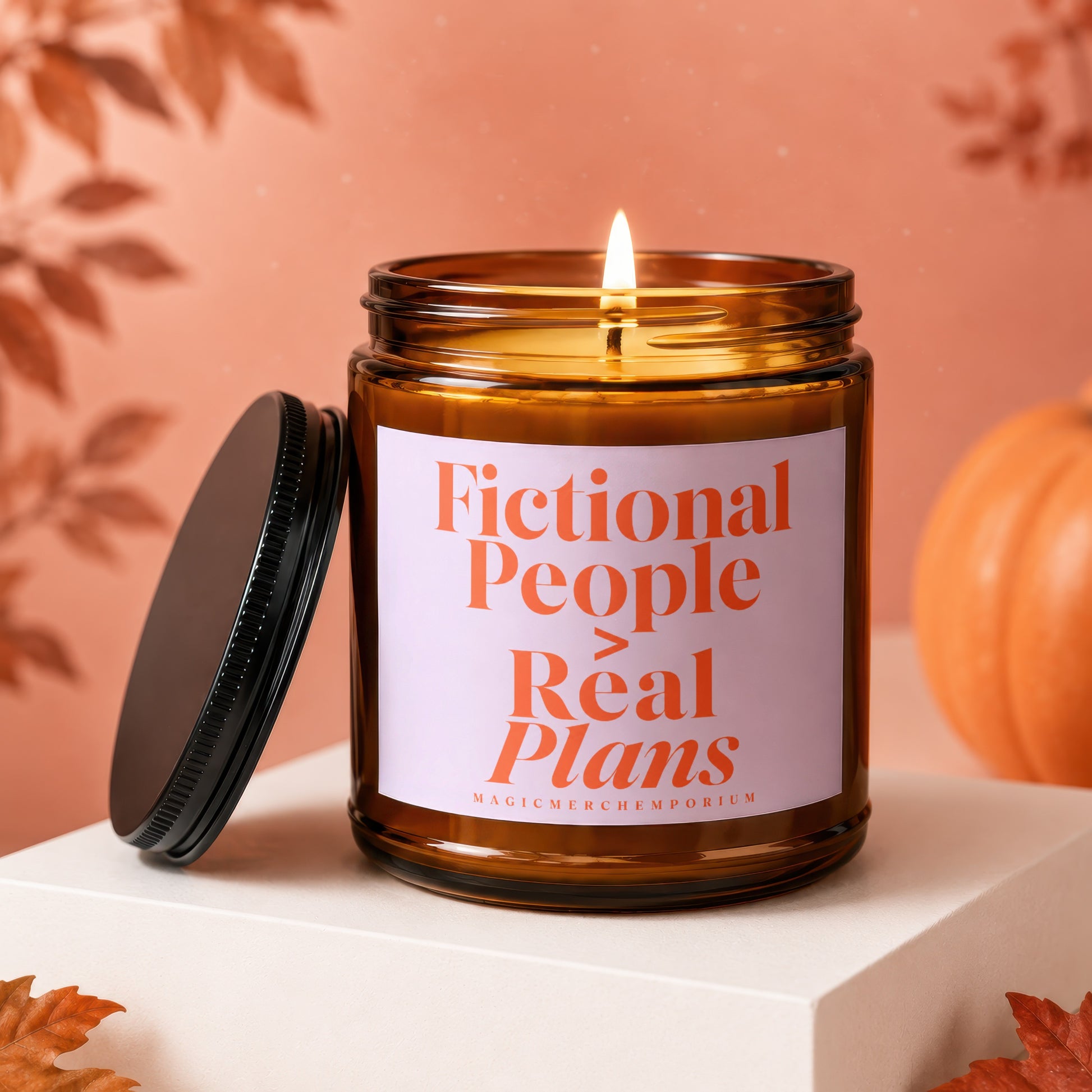 Amber jar candle with lit wick, "Fictional People Real Plans" text, and fall decor.