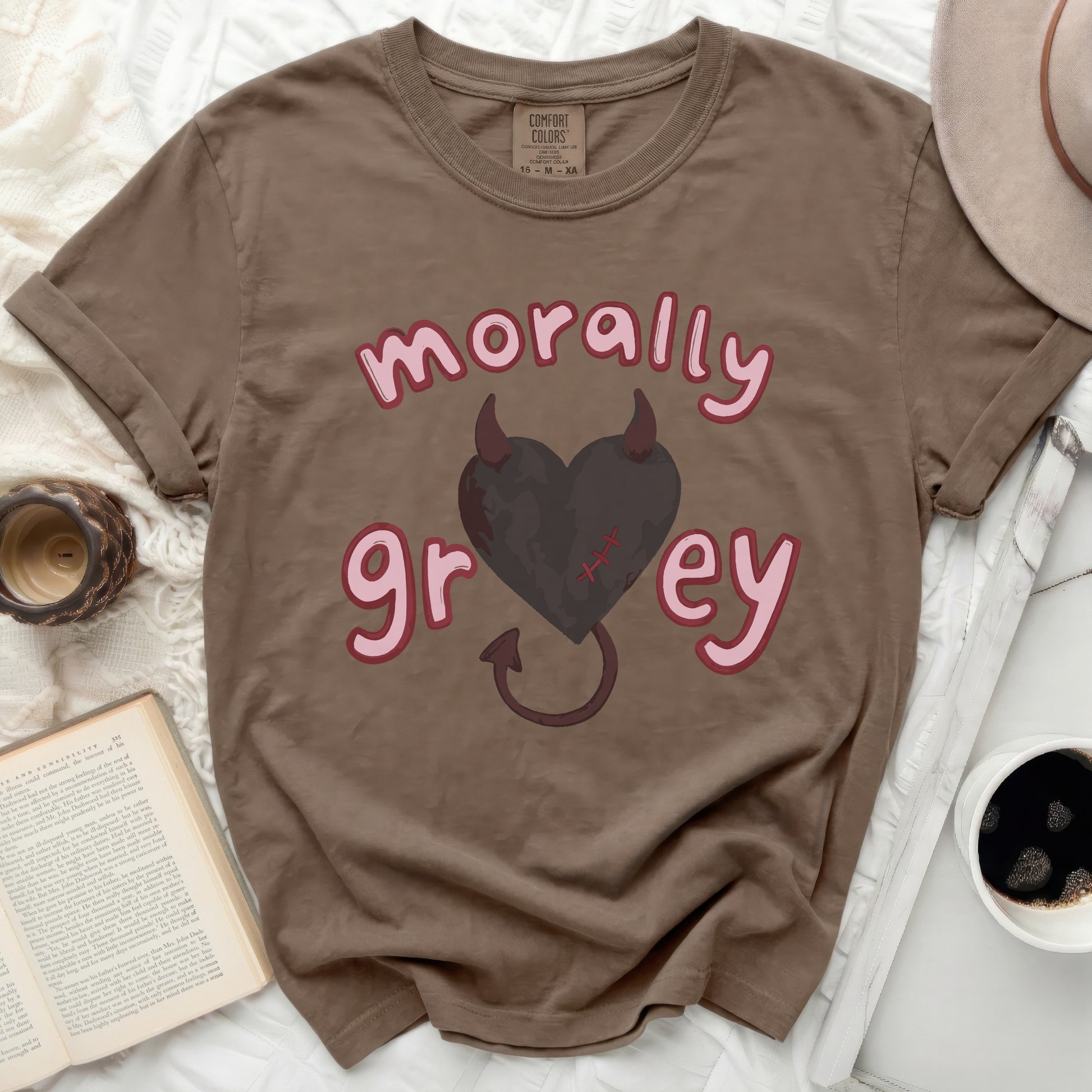 Brown t-shirt with "morally grey" text and a heart with devil horns.
