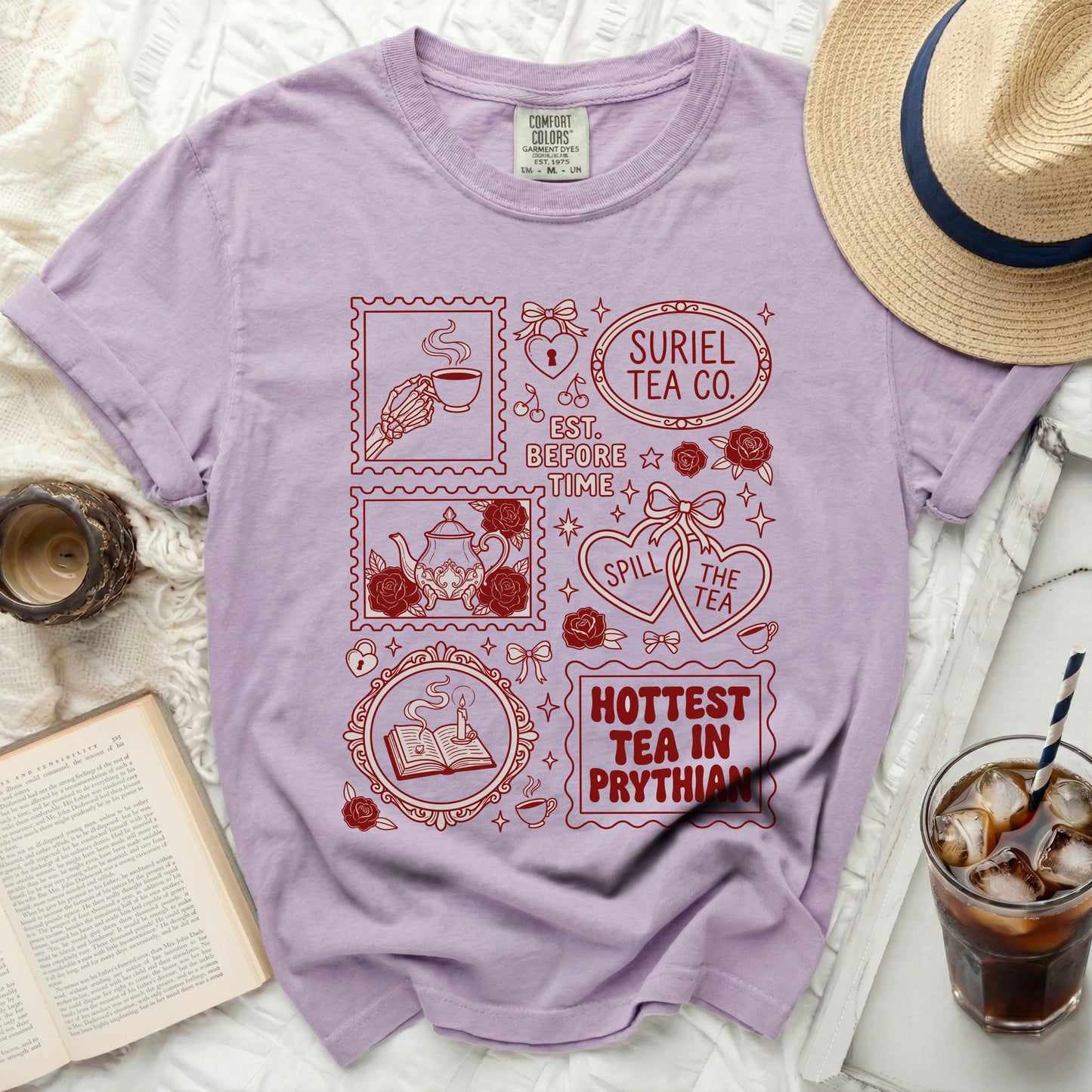 Lilac t-shirt with vintage-style red stamp graphics and text.