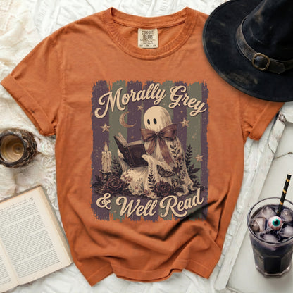 Orange t-shirt with a ghost reading and text "Morally Grey & Well Read".