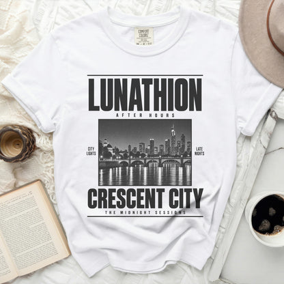 White t-shirt with black text "LUNATHION AFTER HOURS" above city lights and "CRESCENT CITY THE MIDNIGHT SESSIONS".