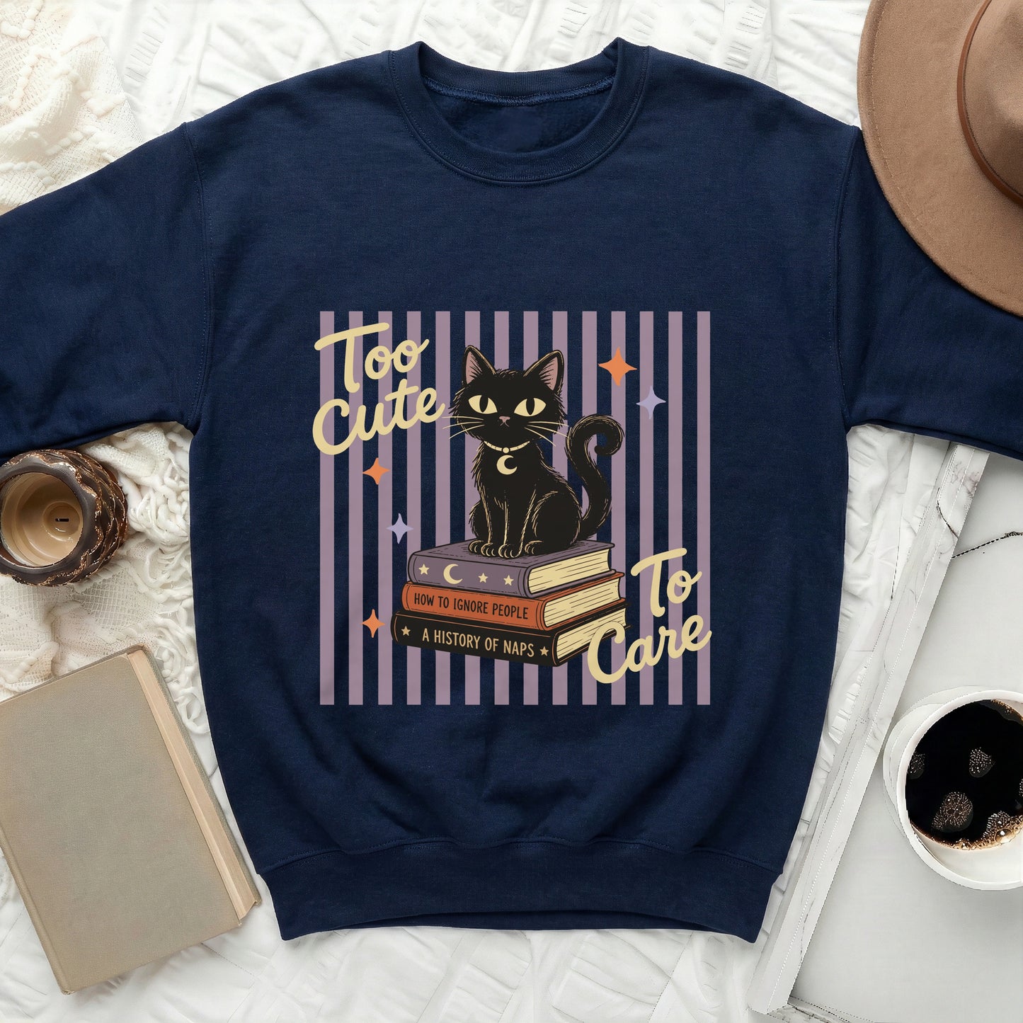 Navy sweatshirt with graphic "Too Cute To Care" black cat on books.