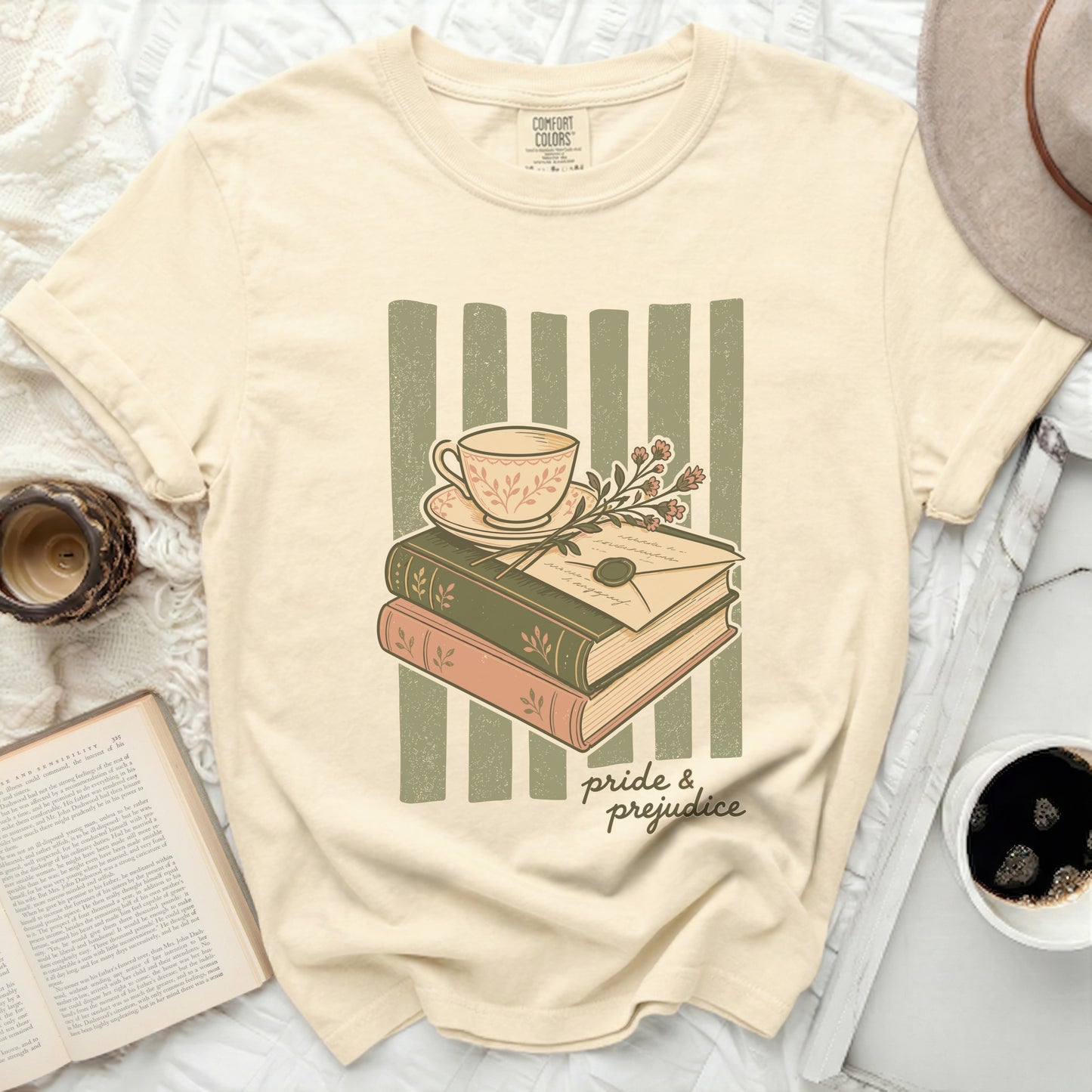 Cream t-shirt with "Pride & Prejudice" book and teacup graphic.