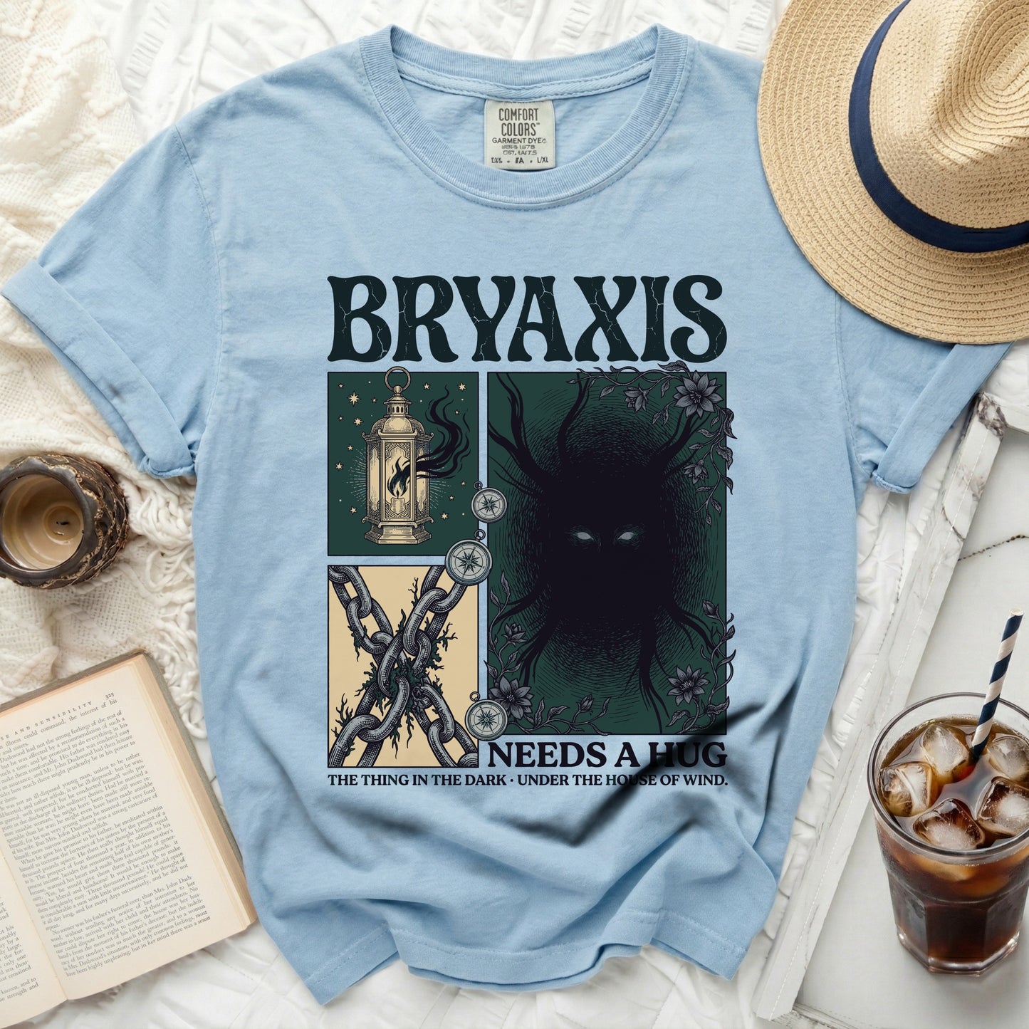 Light blue t-shirt with Bryaxis "Needs a Hug" graphic, featuring a lantern, chains, and dark creature.