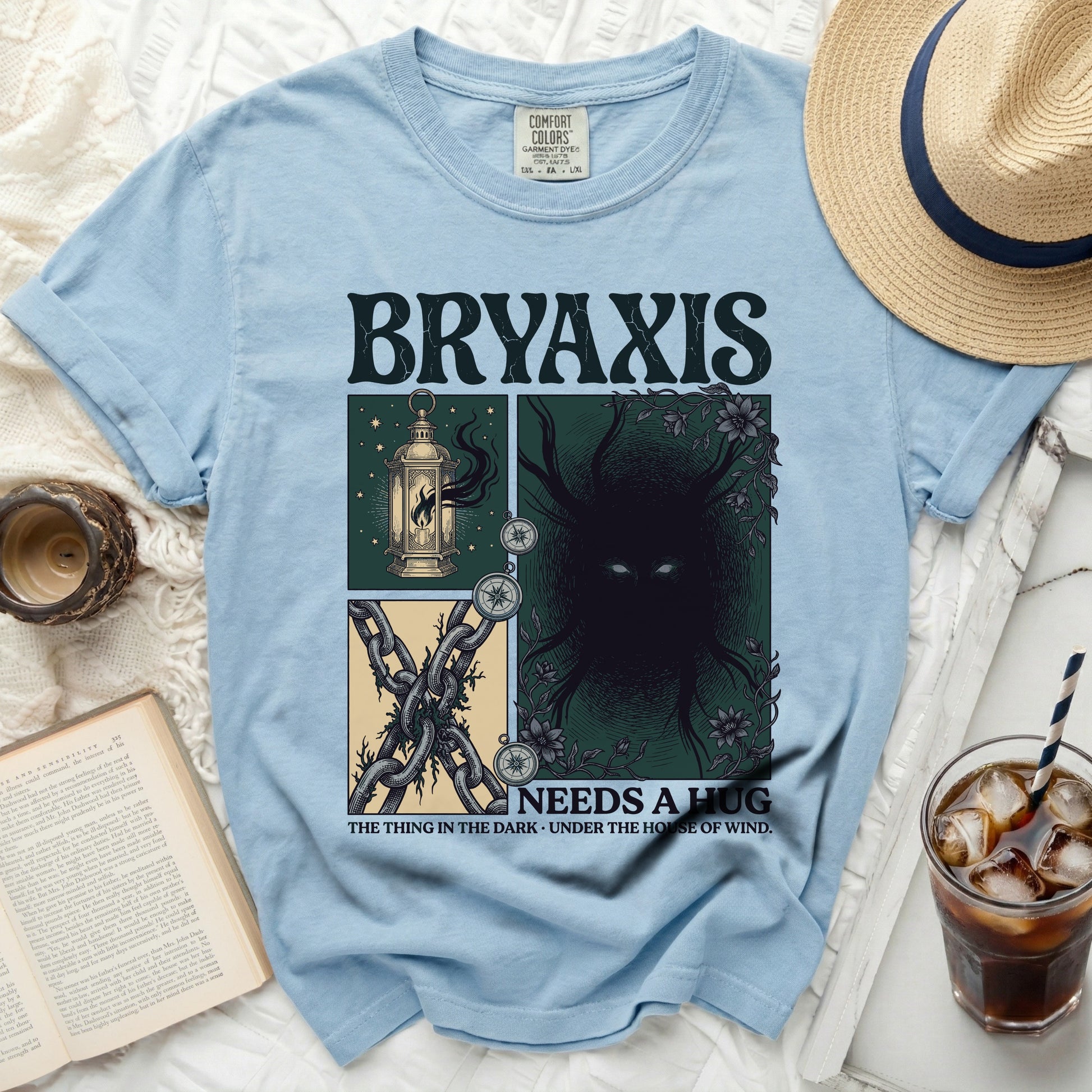 Light blue t-shirt with Bryaxis "Needs a Hug" graphic, featuring a lantern, chains, and dark creature.