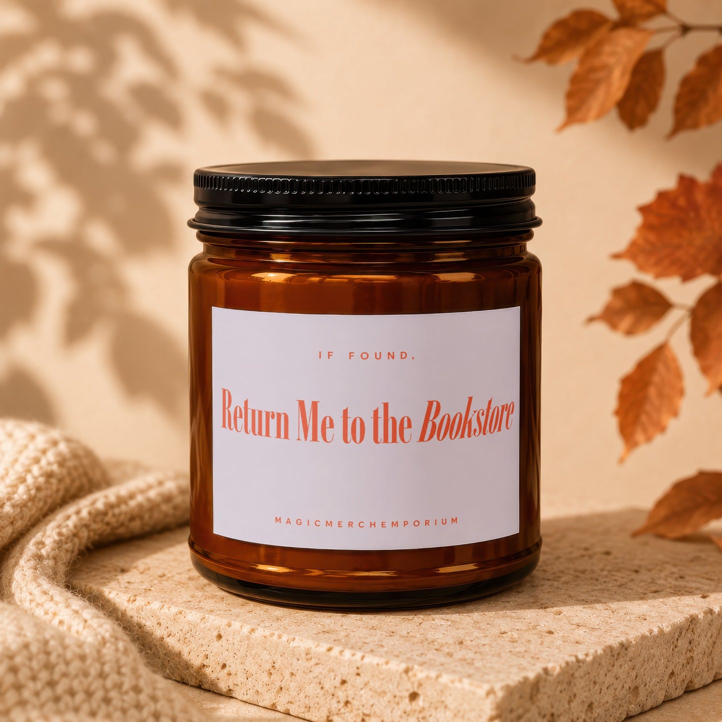 Amber candle with black lid labeled "Return Me to the Bookstore".
