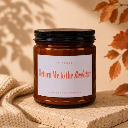 Amber candle with black lid labeled "Return Me to the Bookstore".