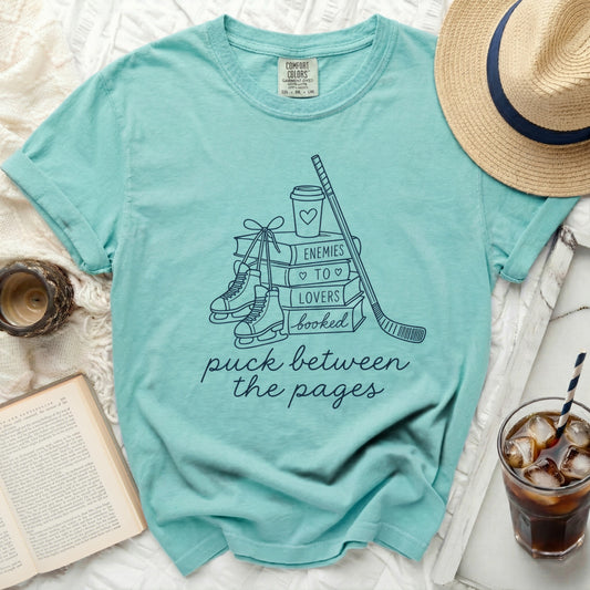 T-shirt with ice skates, hockey stick, book, and "puck between the pages" text.