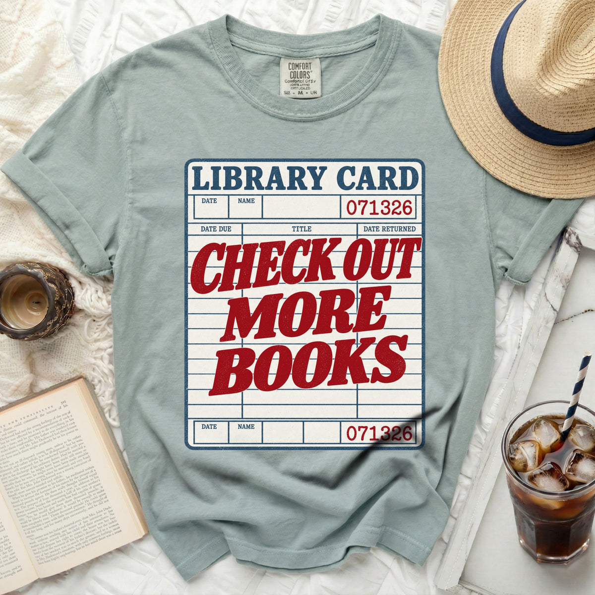 T-shirt with "Library Card Check Out More Books" graphic.