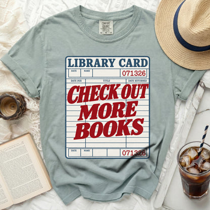T-shirt with "Library Card Check Out More Books" graphic.