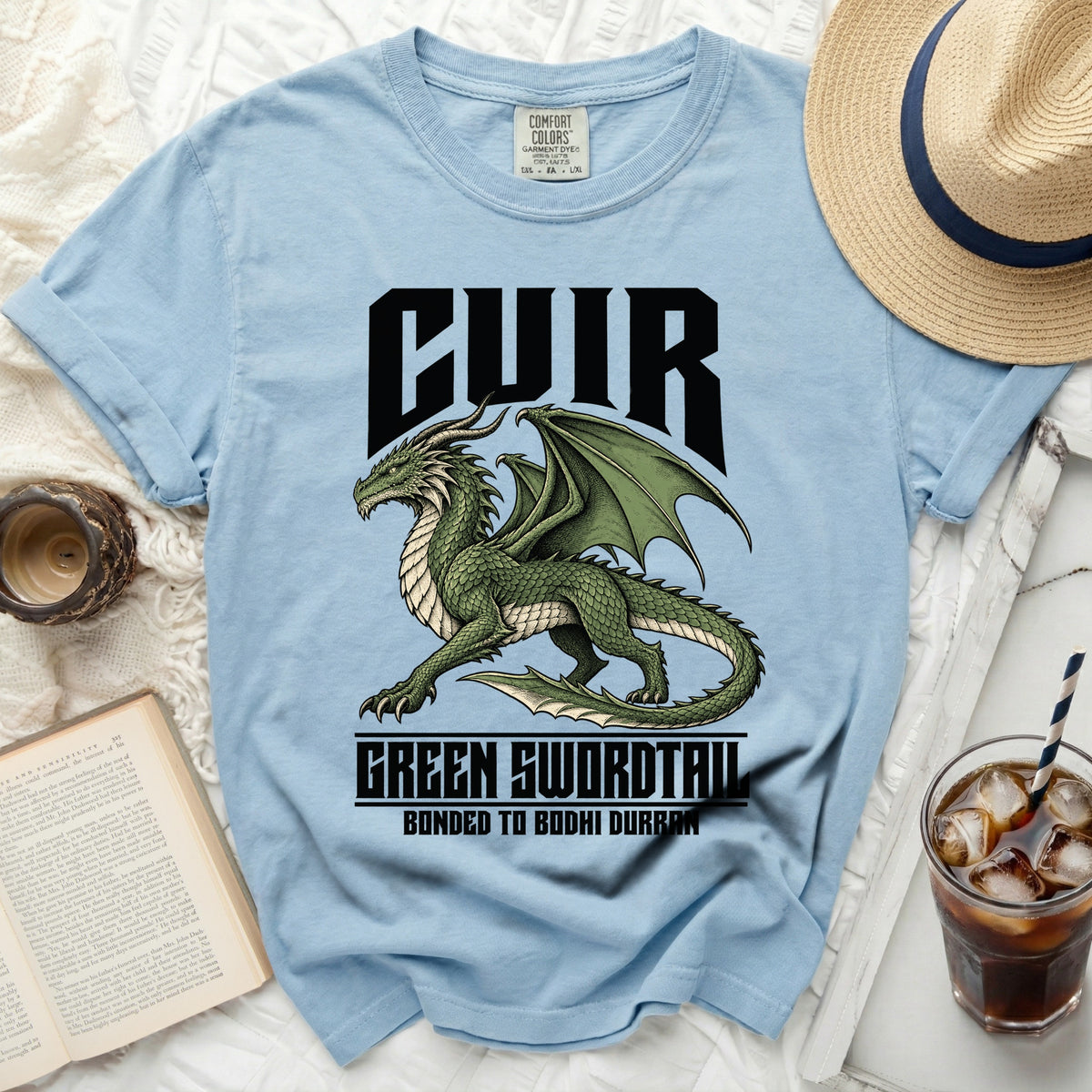 Light blue t-shirt with green dragon graphic and text "CUIR GREEN SWORDTAIL BONDED TO BODHI DURRAN".
