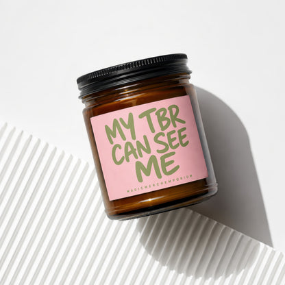 Amber jar candle with pink label reading "My TBR Can See Me"