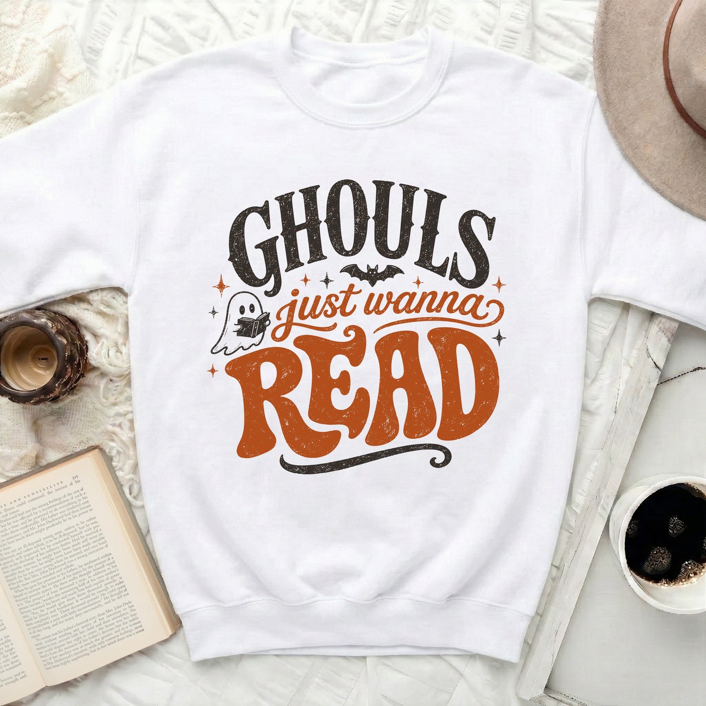 White sweatshirt with "Ghouls just wanna READ" Halloween graphic.