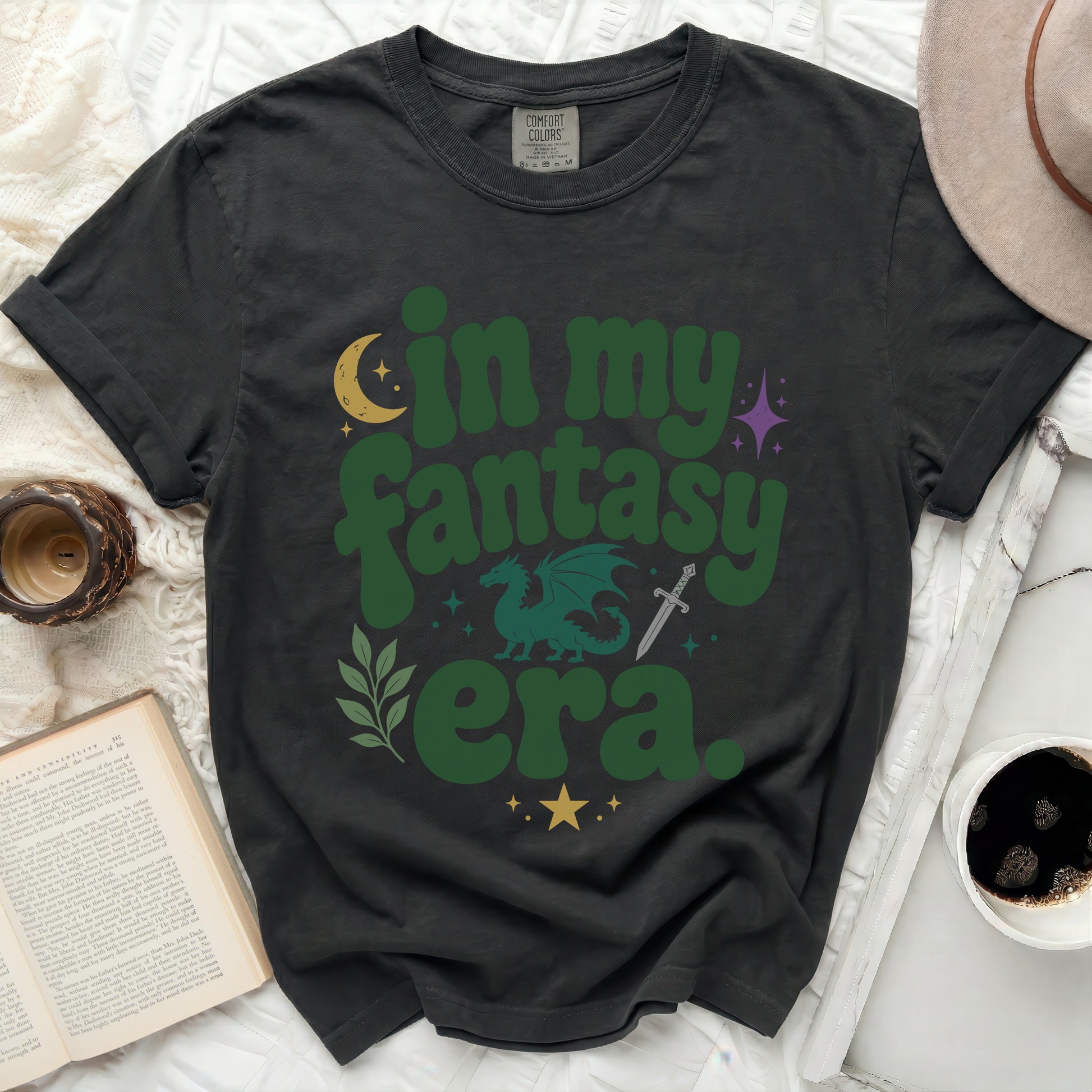 Dark t-shirt with "in my fantasy era" text, dragon, and sword graphic.