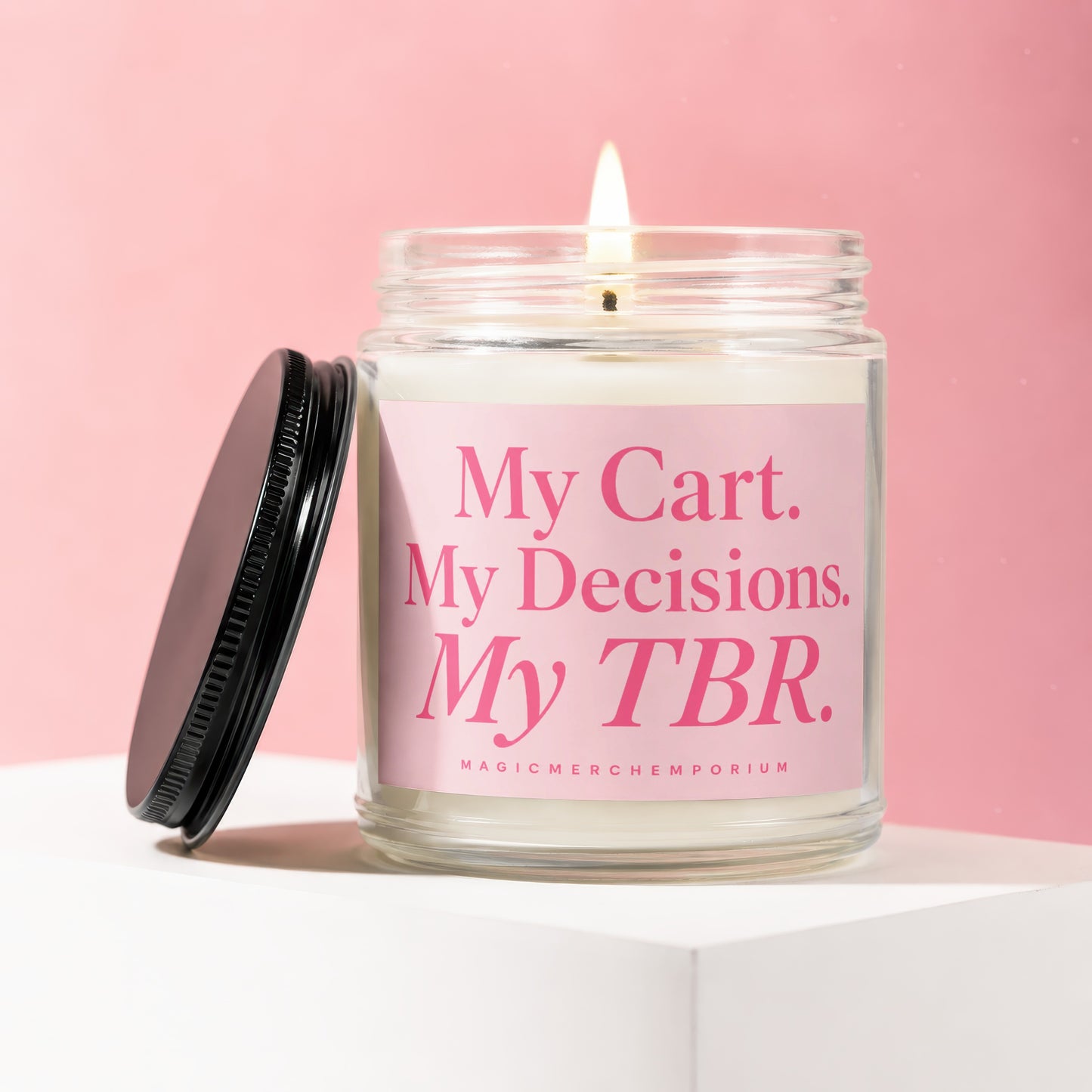 Lit candle in a glass jar with pink label reading "My Cart. My Decisions. My TBR."