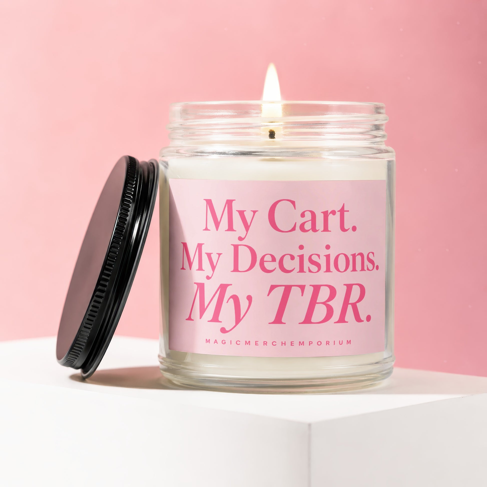 Lit candle in a glass jar with pink label reading "My Cart. My Decisions. My TBR."
