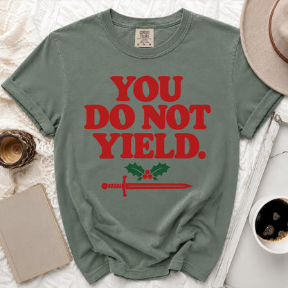 Green t-shirt with red "YOU DO NOT YIELD" text and sword with holly.
