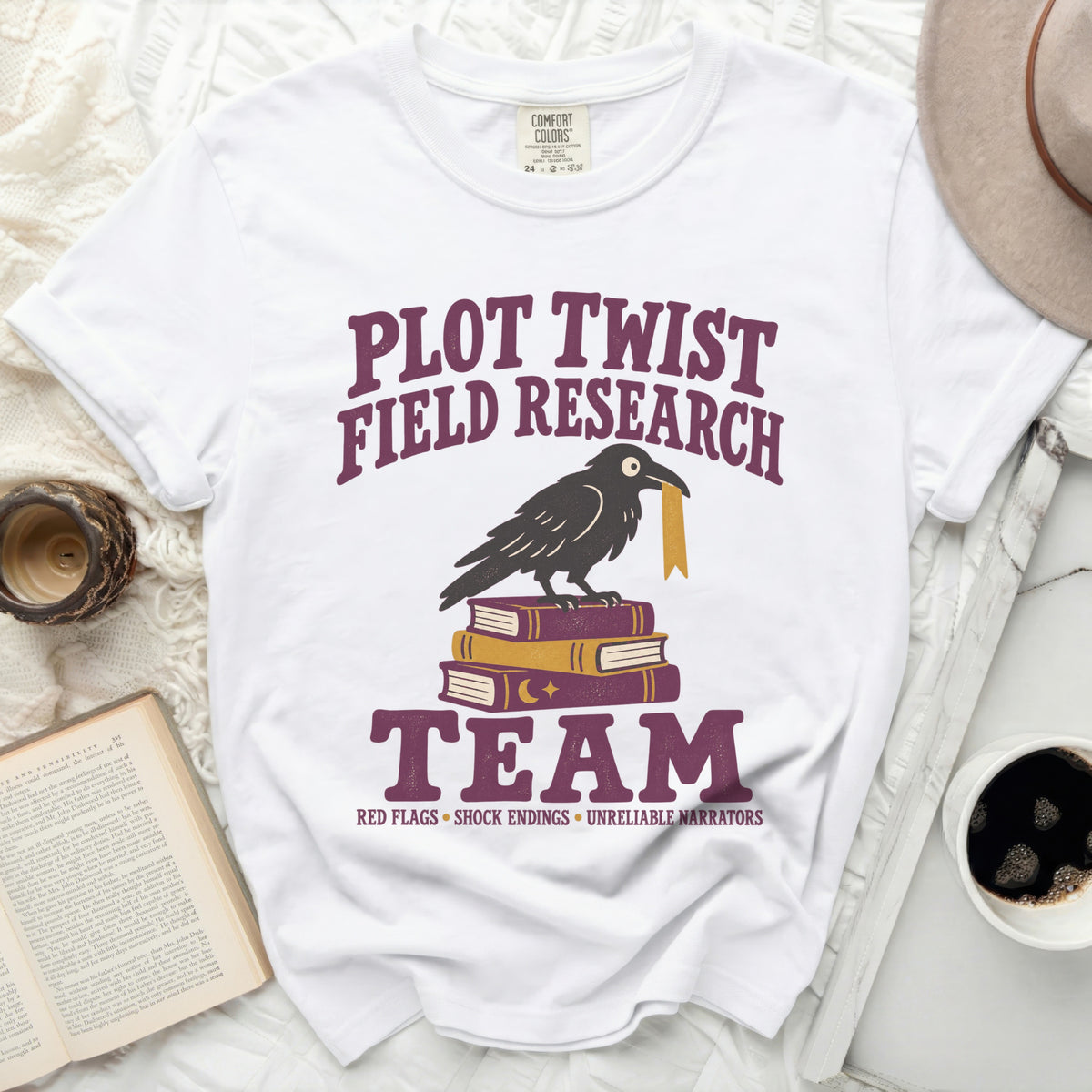 Plot Twist Field Research Team shirt with raven on books.