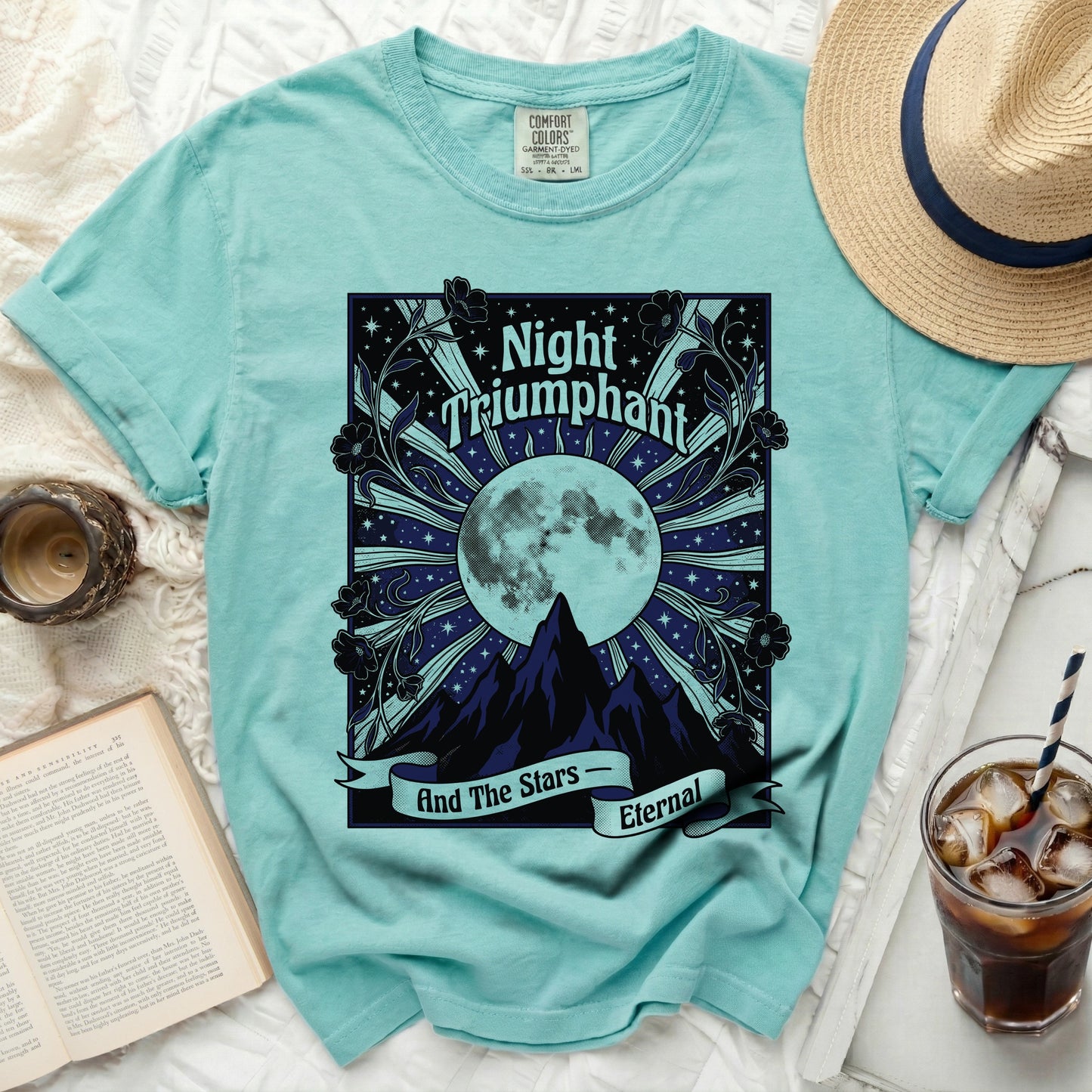 Teal t-shirt with "Night Triumphant And The Stars Eternal" graphic.