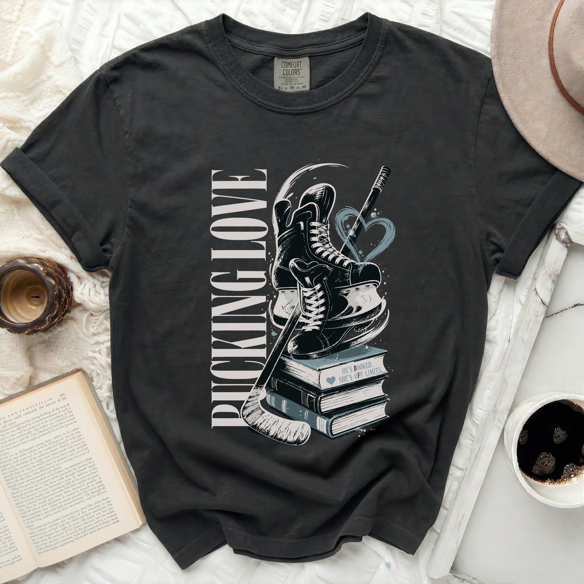 Black t-shirt with "Pucking Love" and hockey graphics on books.