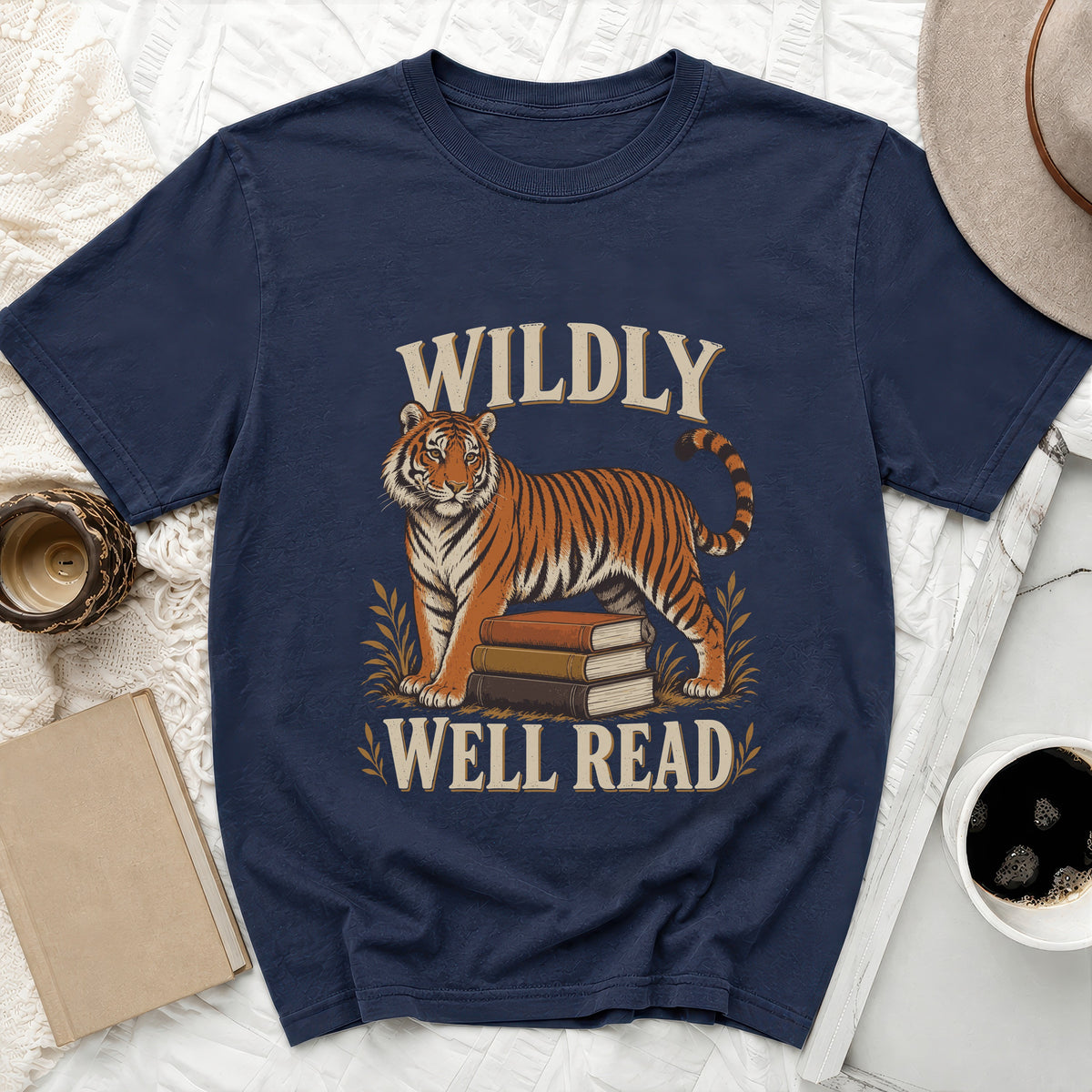 Navy t-shirt with tiger and books graphic, reads "Wildly Well Read".