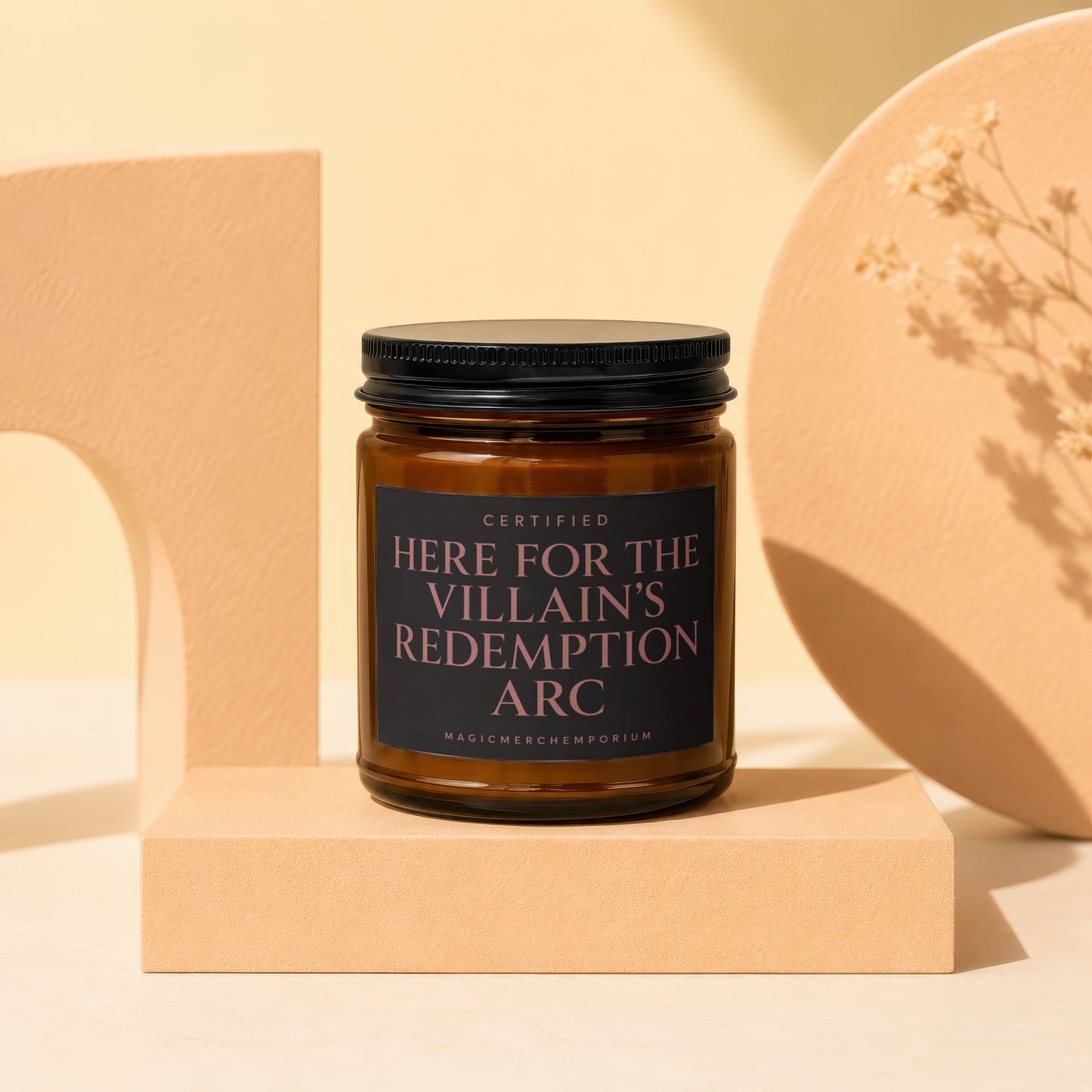 Amber candle with black lid and label reading "Certified Here For The Villain's Redemption Arc".