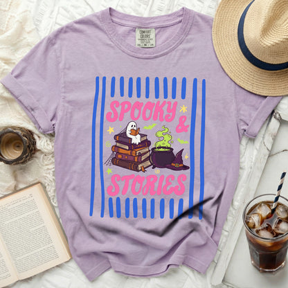 Purple Comfort Colors t-shirt with "Spooky & Stories" Halloween graphic.