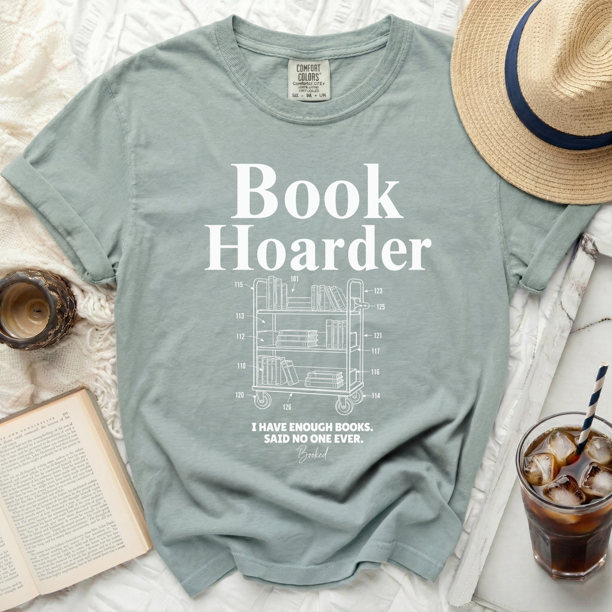 Light sage green t-shirt with "Book Hoarder" and a book cart graphic.