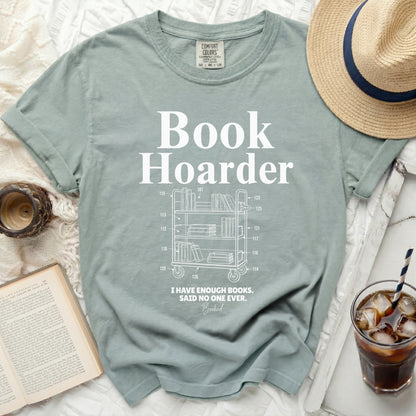 Light sage green t-shirt with "Book Hoarder" and a book cart graphic.