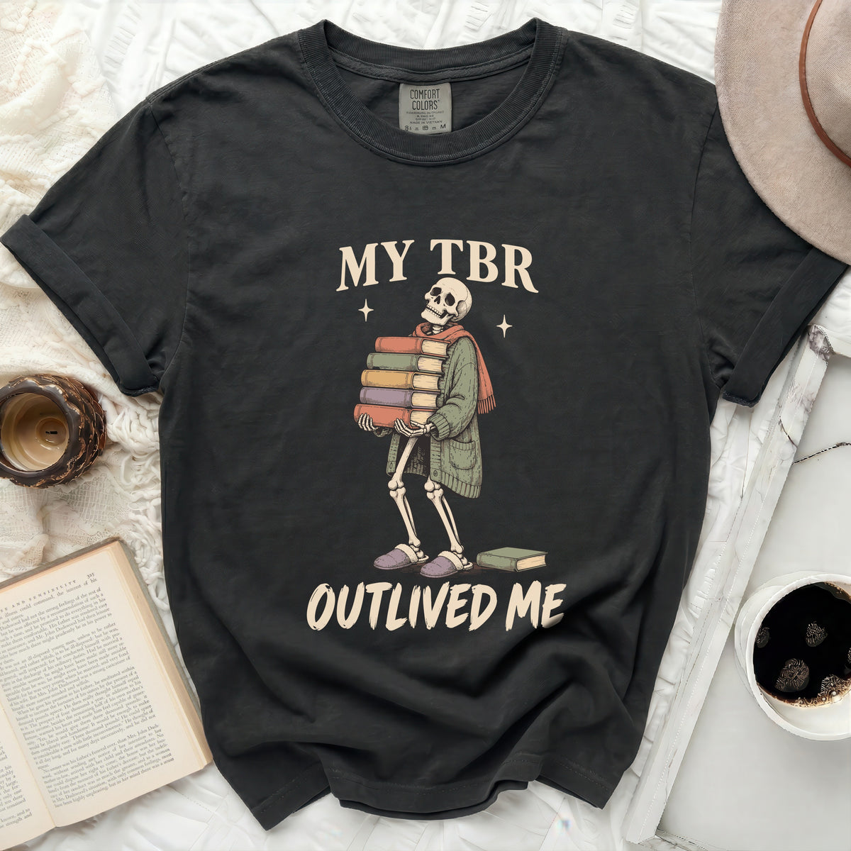 Black t-shirt with a skeleton holding books and text that says "MY TBR OUTLIVED ME".