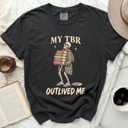 Black t-shirt with a skeleton holding books and text that says "MY TBR OUTLIVED ME".