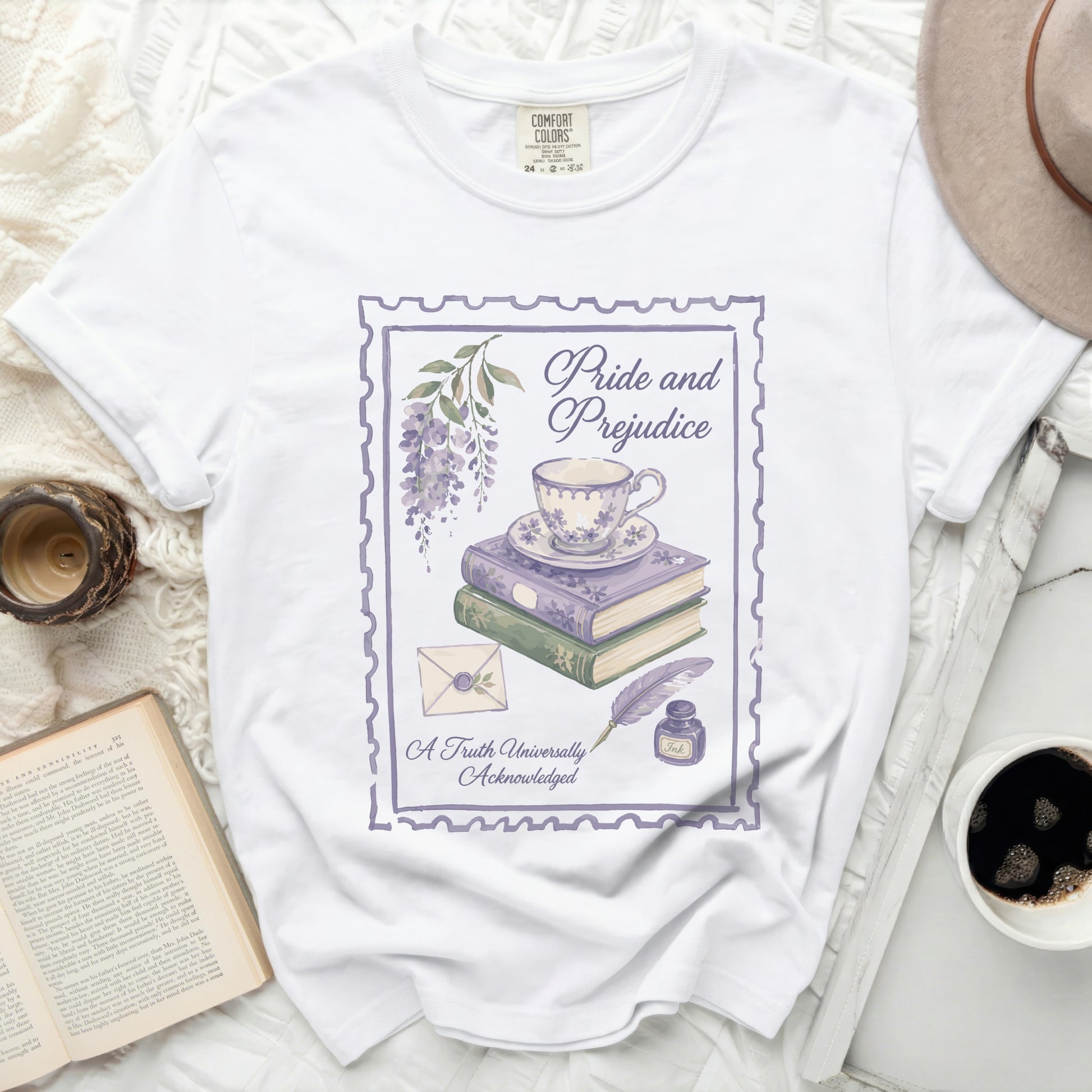 White t-shirt with vintage "Pride and Prejudice" design featuring books and teacup.