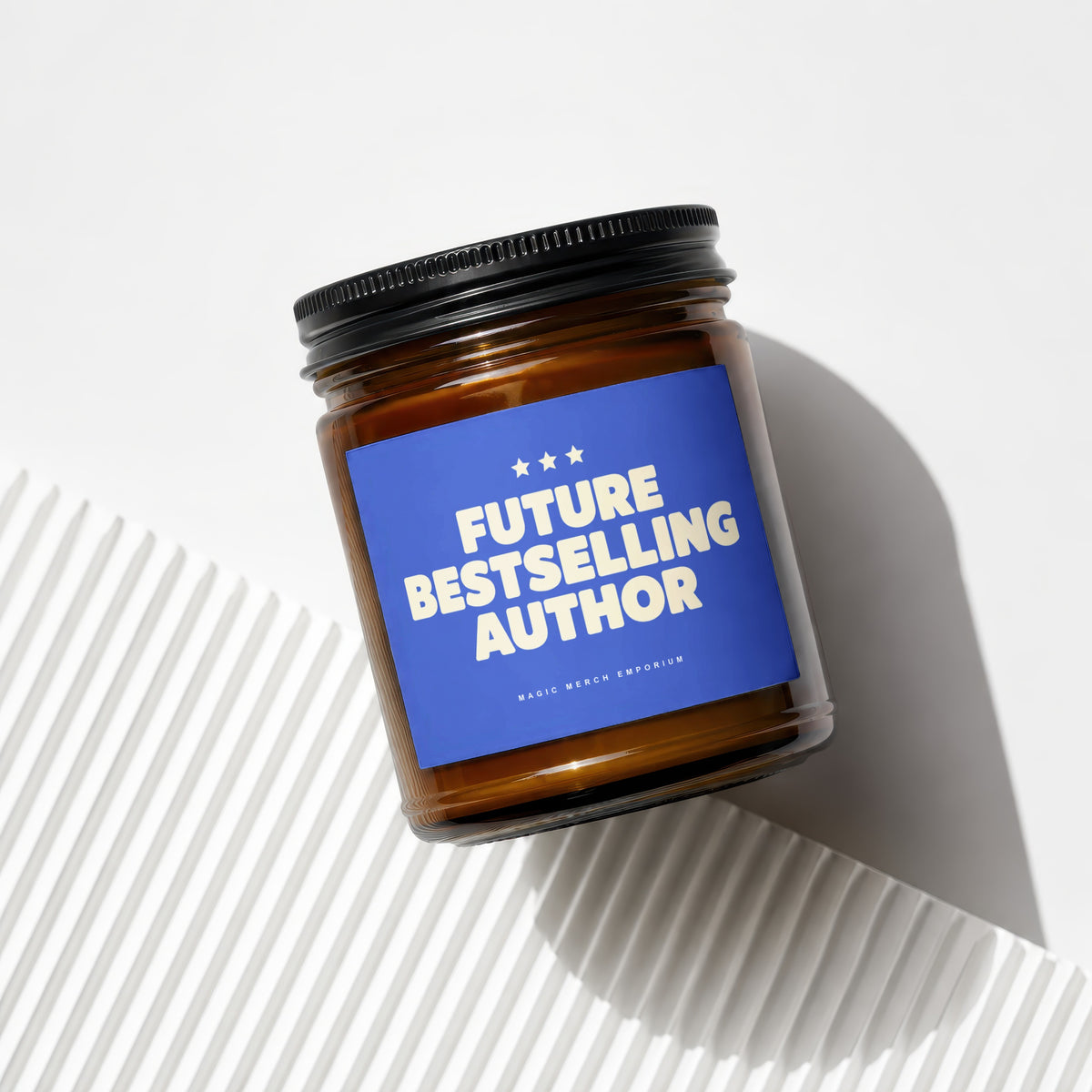 Amber jar candle with blue label that reads "FUTURE BESTSELLING AUTHOR".