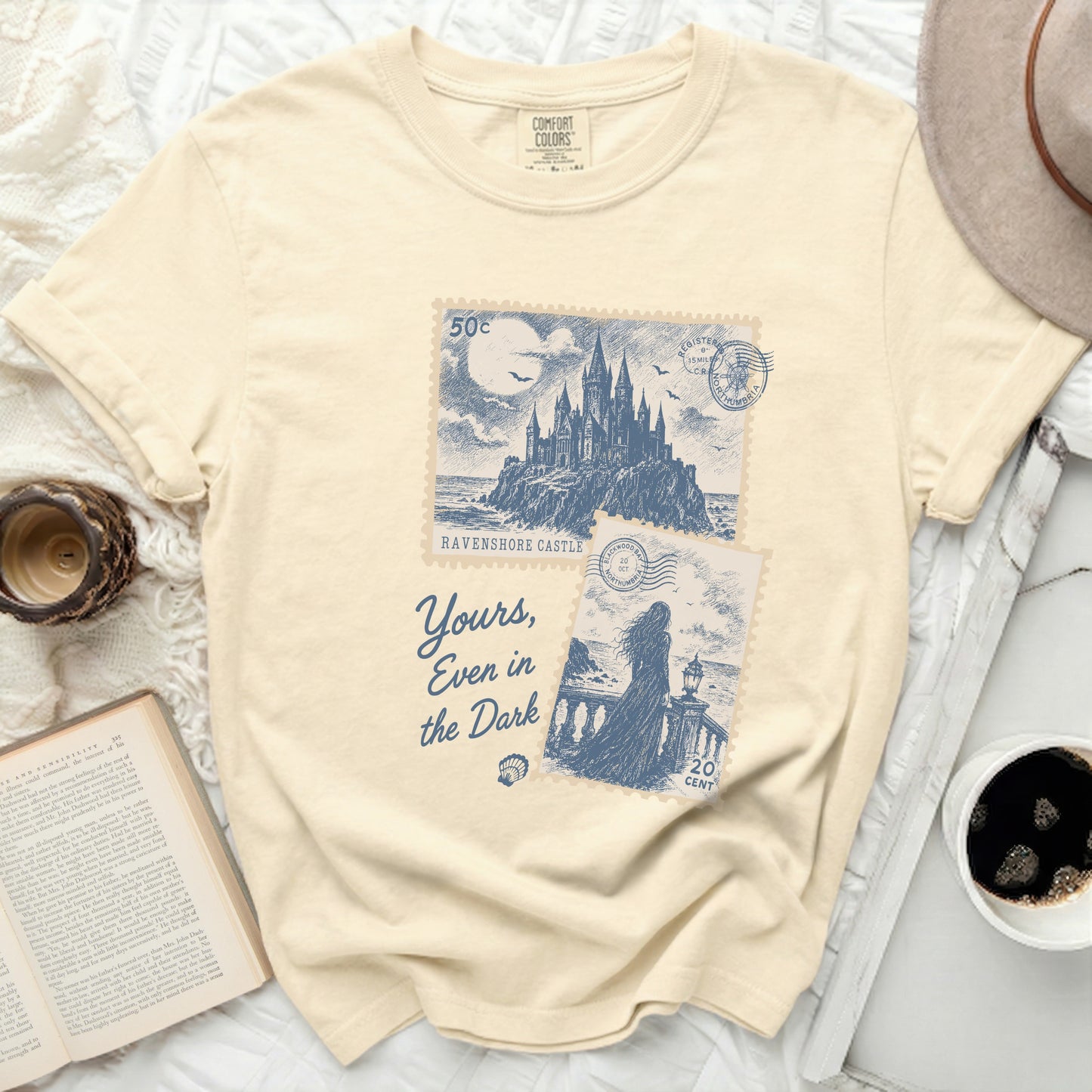 Cream t-shirt with "Ravenshore Castle" and "Yours, Even in the Dark" text.