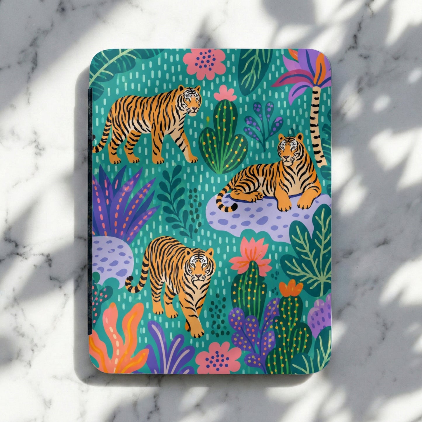 Notebook cover with stylized tigers and jungle foliage on a teal background.