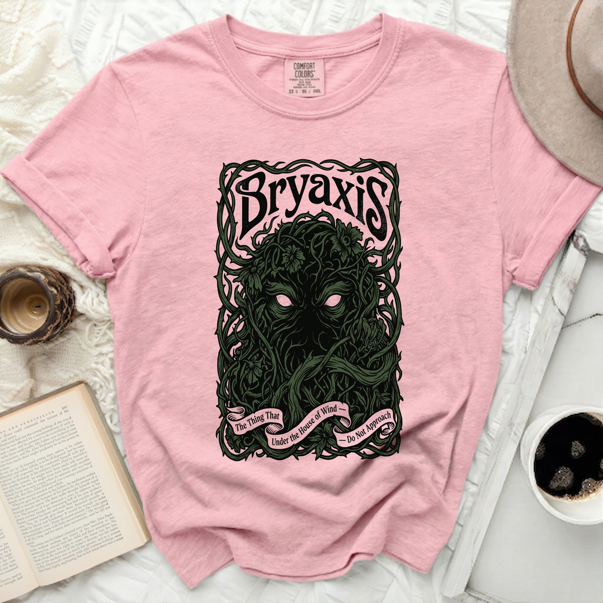 Bryaxis graphic on a pink t-shirt with text "The Thing That Under the House of Wind - Do Not Approach".