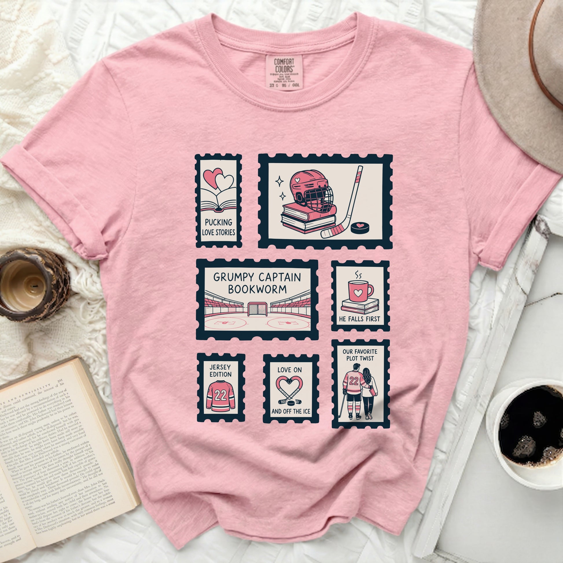 Pink t-shirt with postage stamps featuring hockey and book themes.