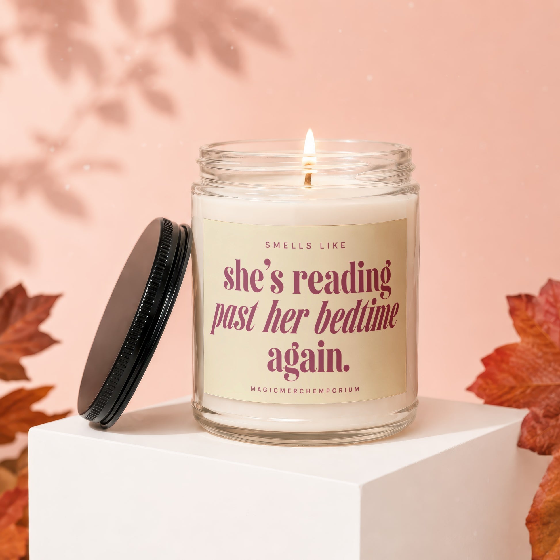 Scented candle with text "she's reading past her bedtime again."
