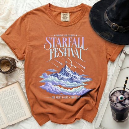 Orange t-shirt with "Starfall Festival" graphic featuring mountains and clouds.