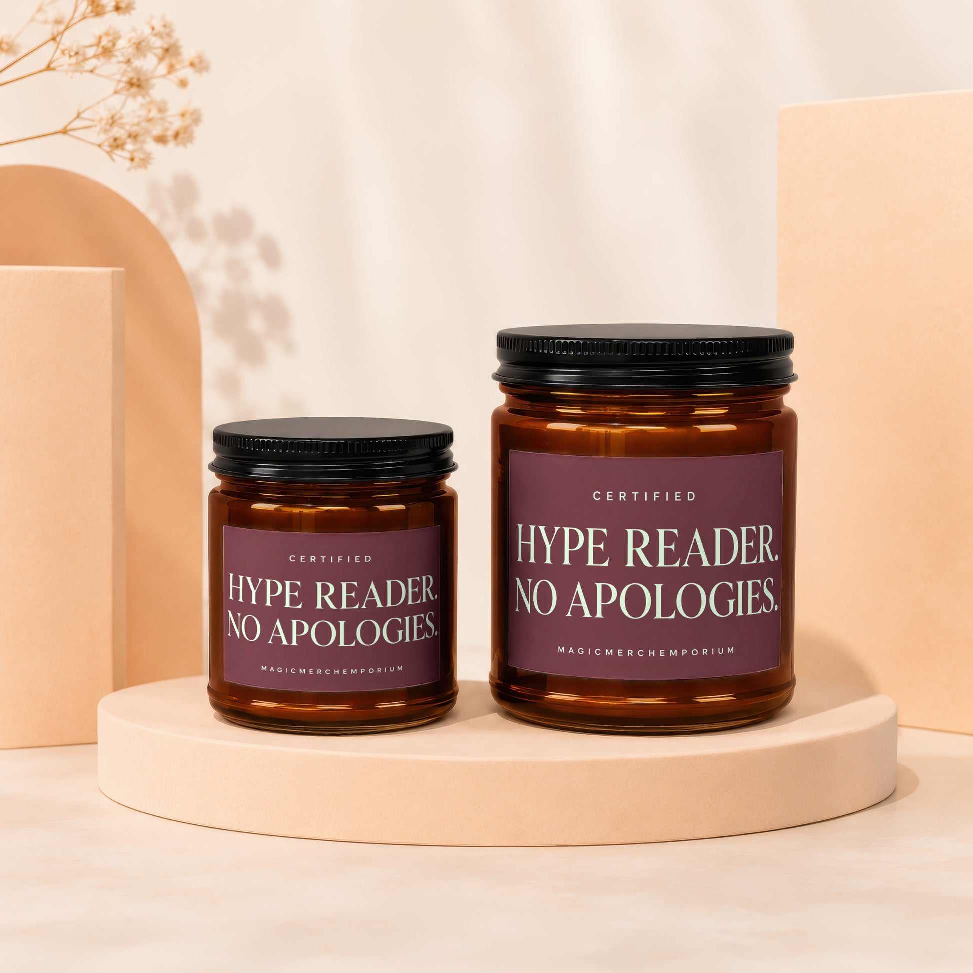 Two scented candles with labels that read "Certified Hype Reader. No Apologies."